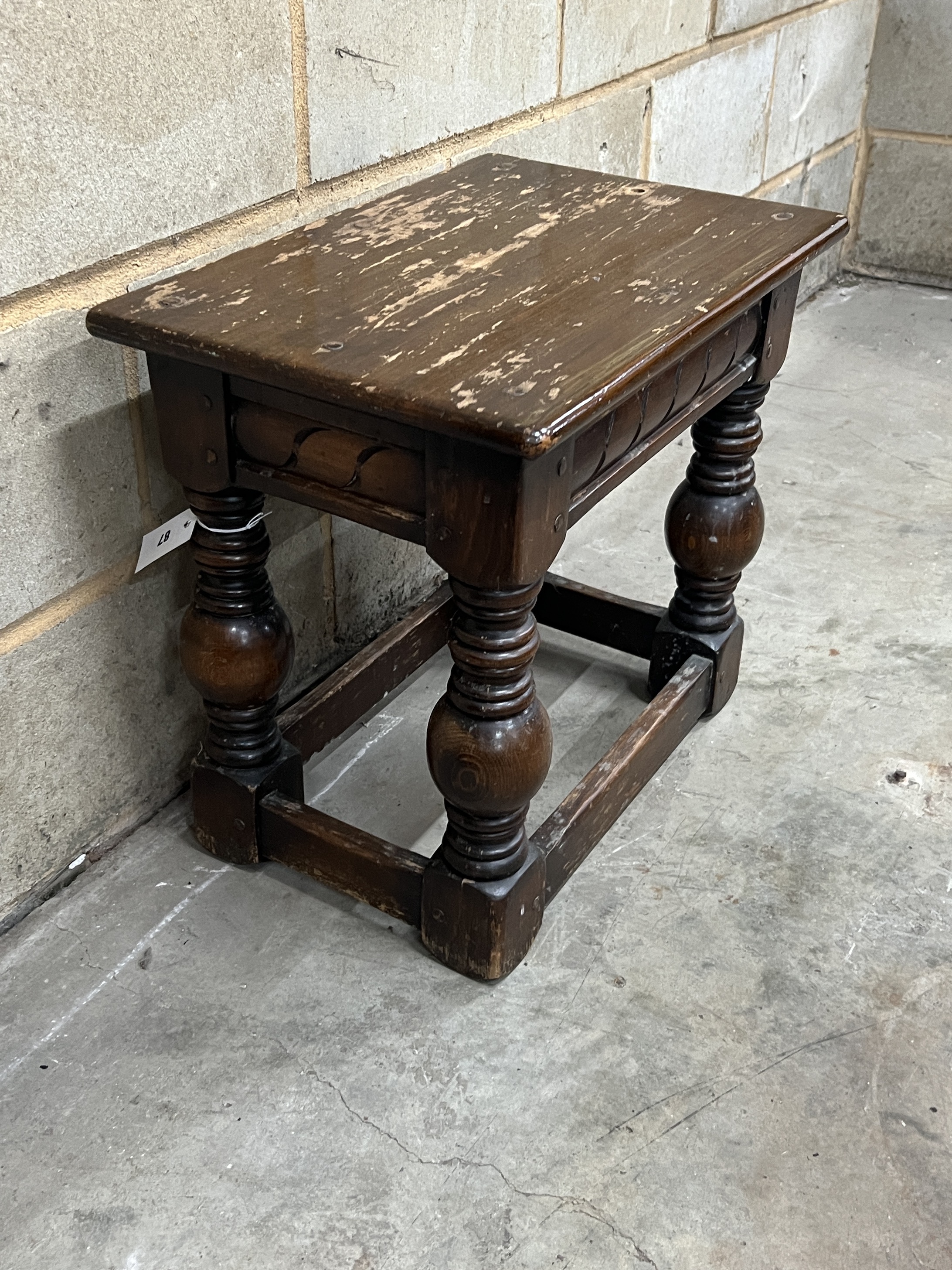 A rectangular 17th century style joint stool, width 53cm, height 48cm, together with a pair of carved table bases